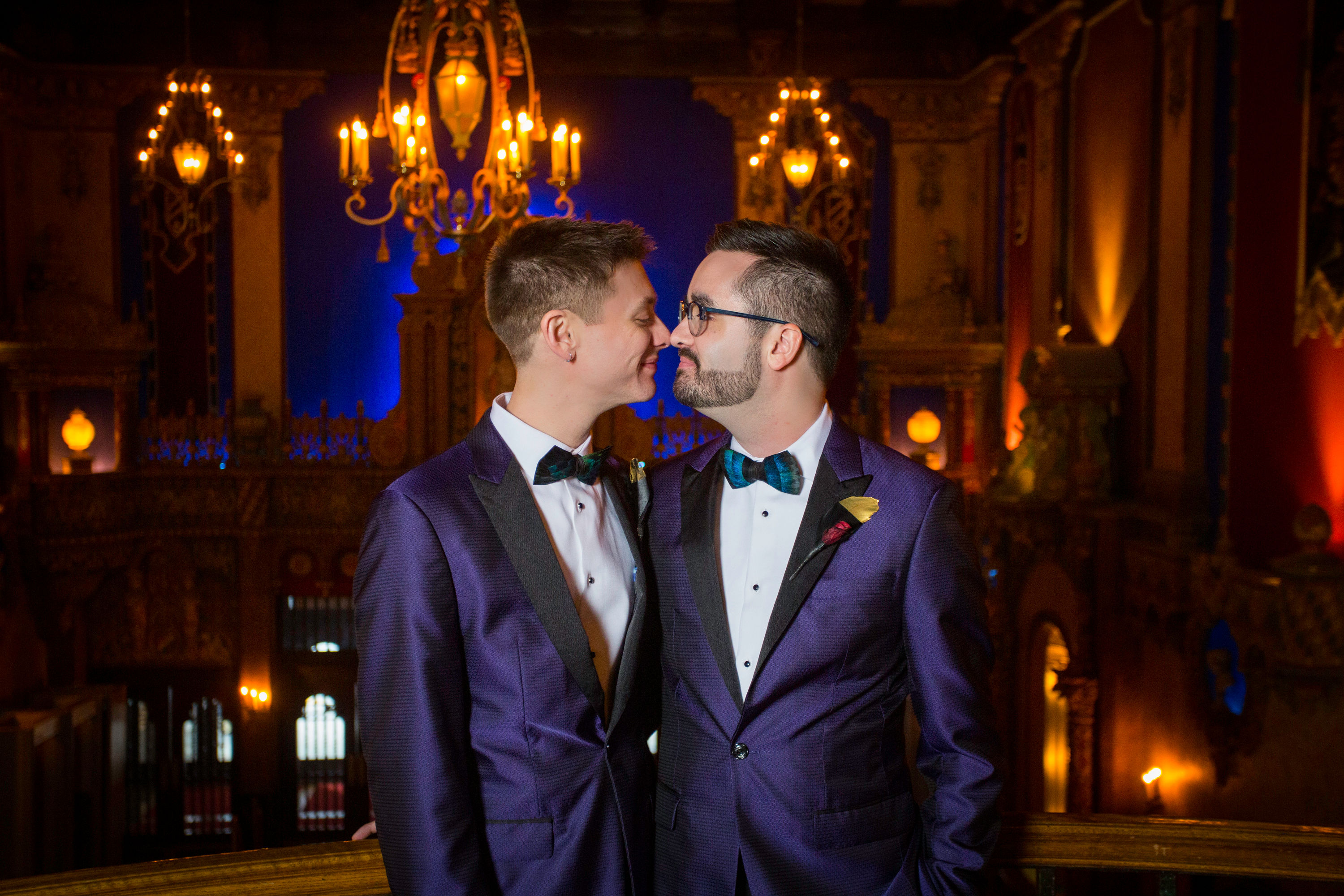 Two men in tuxedos smile lovingly at each other on their wedding day at Live Nation Special Events’ Louisville Palace