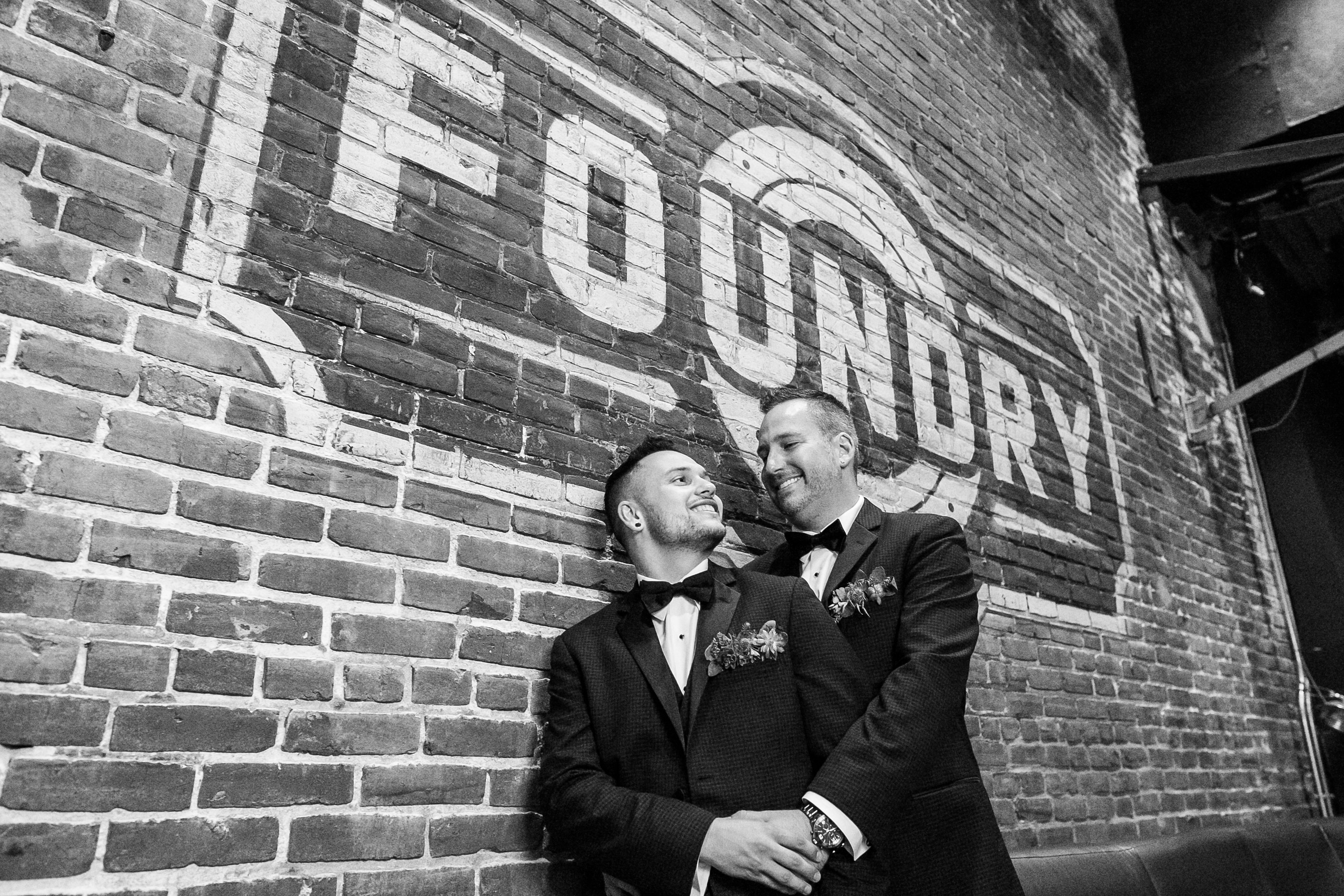 Two men in tuxedos smile lovingly at each other on their wedding day at Live Nation Special Events’ The Fillmore Philadelphia